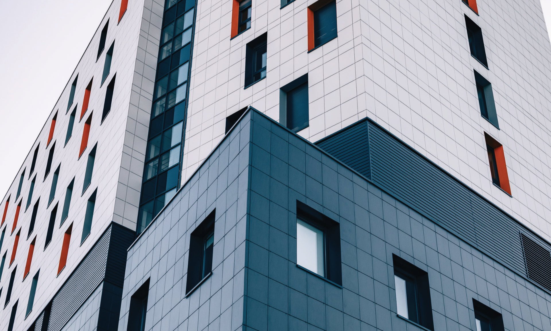 Bespoke stone cladding on a tower block illustrating our custom stone solutions for commercial trades
