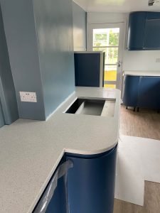 Polished quartz countertops with curved and straight sections.