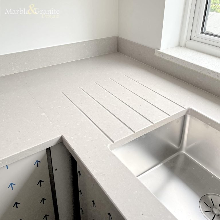 Worktop upstands, drainage grooves and polished sink cutout feature in this corner-shot of an MGD-installed quartz worktop