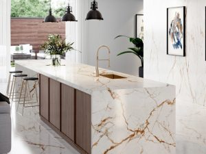 Dekton Awake roomshot featuring white kitchen island with terracotta veining in a modern kitchen setting.