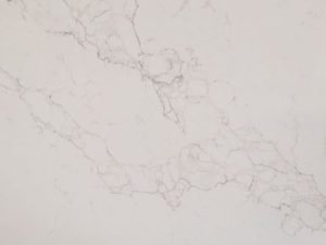 Fine-grained white quartz compound stone with darker grey-brownish irregular veins - Neo Calacatta BQS is a marble-effect quartz surface - swatch