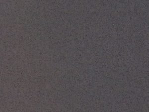 Dark grey quartz surface with a granular appearance - Diresco Beach Dark Grey swatch