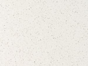 Granular white quartz surface with irregular stone fragment design - Diresco Beach Iceberg swatch