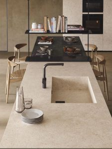Stone-effect surfaces exemplified by this porcelain kitchen worktop in cream.