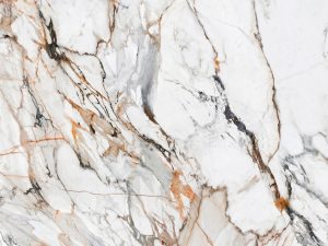 sintered stone swatch showing the product's white base with grey and copper veins in a marble style - calacatta luxe neolith
