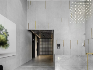Dekton Lunar wall cladding in a modern brutalist reception area with high ceilings and minimal decor