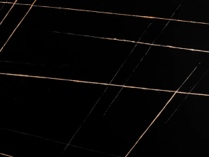 Fine-grained black quartz compound stone with rather straight white/orange veins spread over the surface - Sahara Noir Unistone swatch