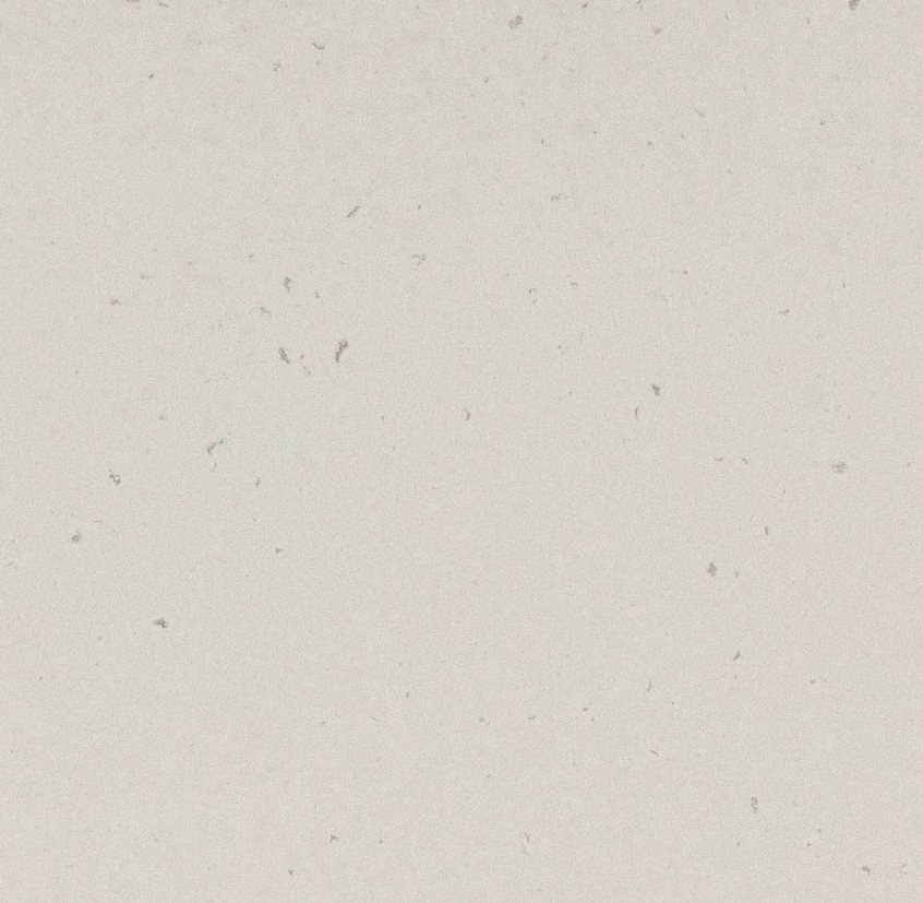 4141 Misty Carrera – swatch. Speckled White Polished Quartz Worktop Faint flecks of light and dark grey add depth and character to a soft white-layered base with an elevated look.