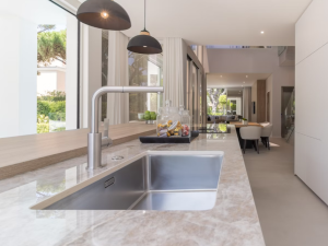 Dekton Arga kitchen worktop with polished sink cutout and stainless steel sink/tap combo in a modern galley kitchen
