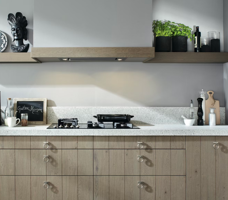 Silestone blanco norte worktops on a natural wood cabinet against a wall with matching wooden floating shelf on a light beige wall.