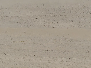 Travertino di Calma product photo: Beige compact limestone (travertine) with pronounced lined drawing. The drawing is very heterogeneous and especially band-shaped (horizontal and parallel; sawn perpendicular to layering). The surface contains small openings that may or may not be filled depending on the demand.