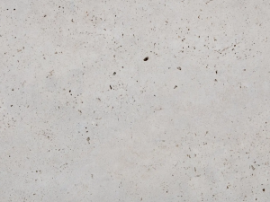 Noce Travertine - Beige compact limestone ("travertine") with "cloud-shaped" structure due to typical pore structure. The surface presents small openings that may or may not be filled (pores are usually filled when installed with adapted grout). Fossils can be present throughout the material.