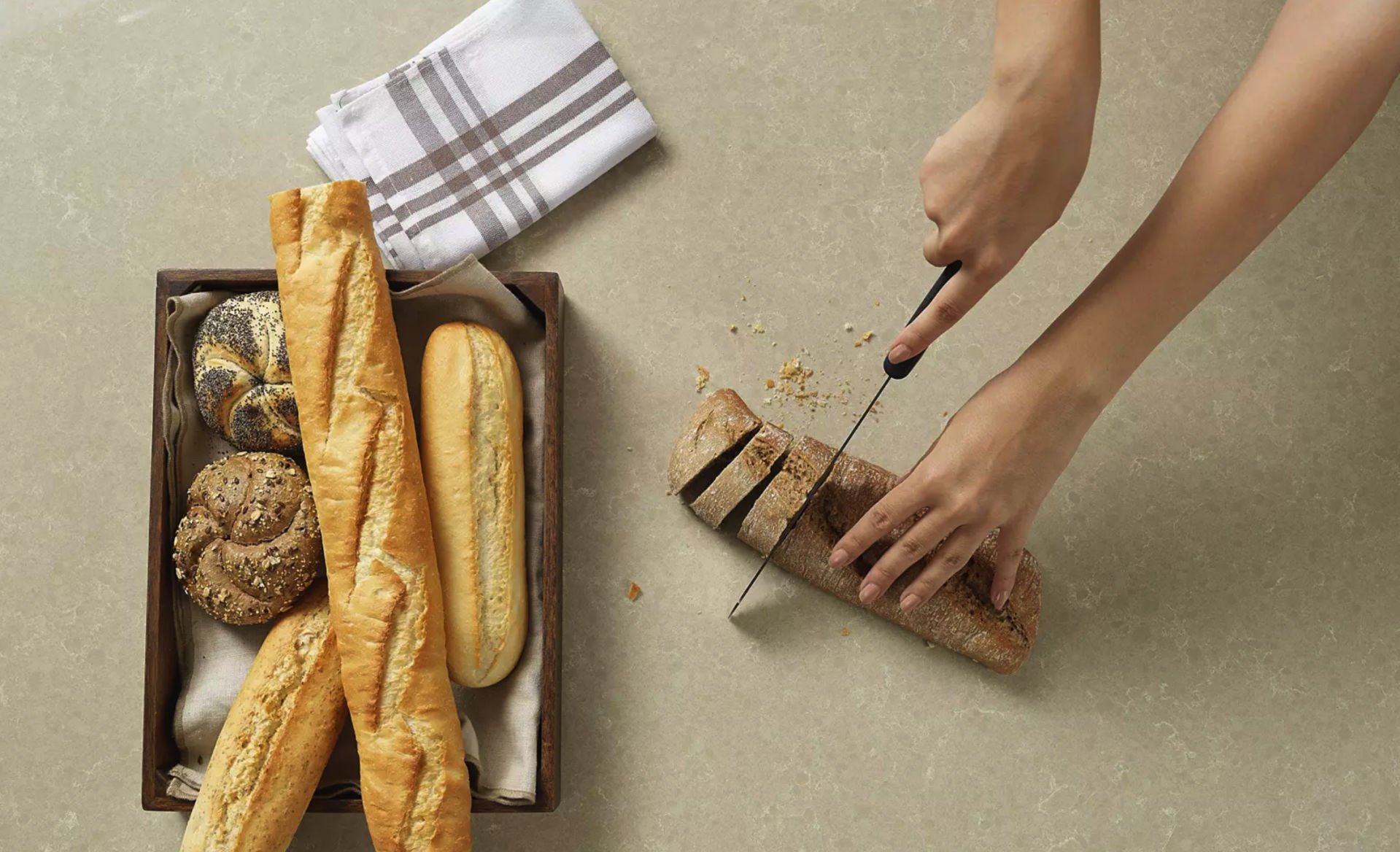 Cutting fresh bread on a Cimstone quartz worktop