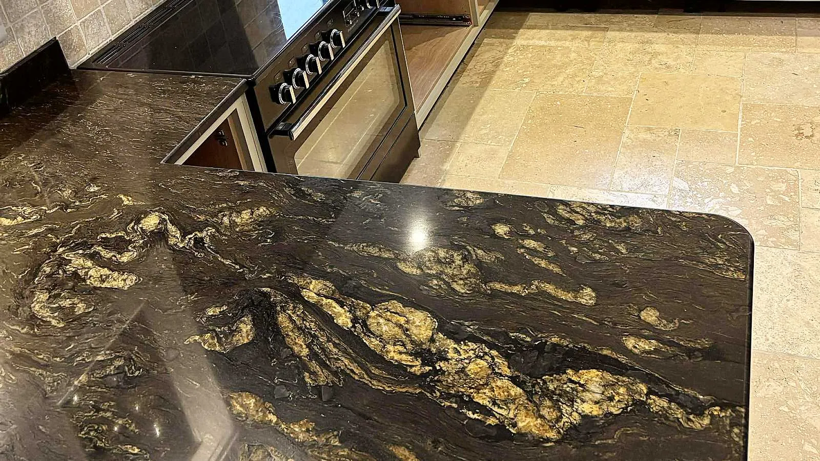Cosmic black yellow granite kitchen worktops installation photo