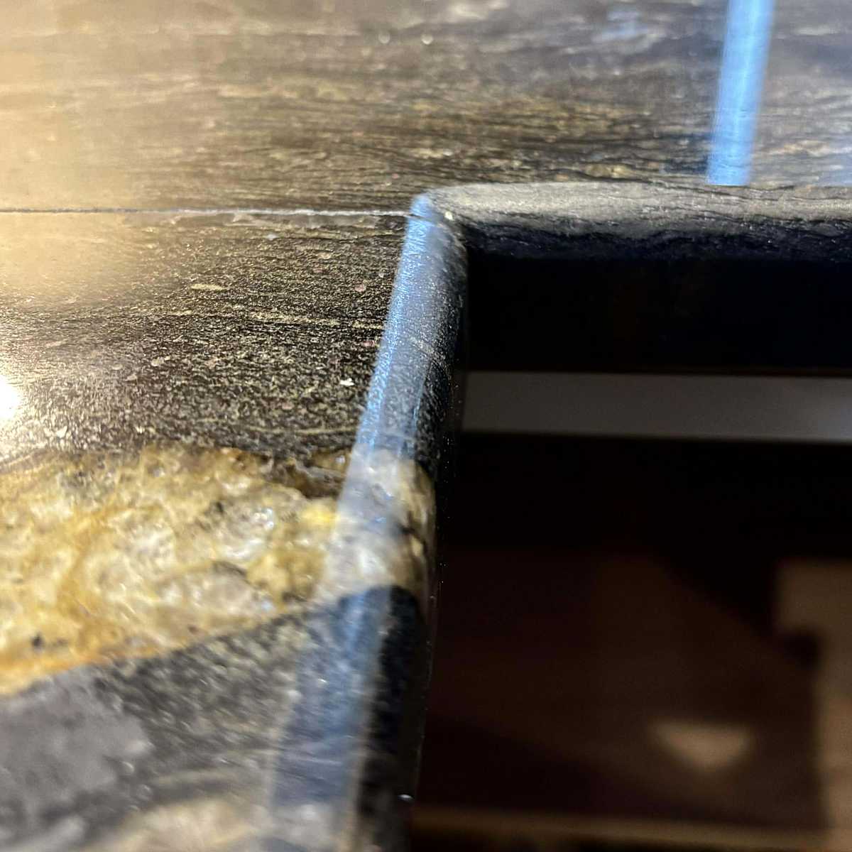 Cosmic Black Yellow Granite - Pencil edge profile closeup